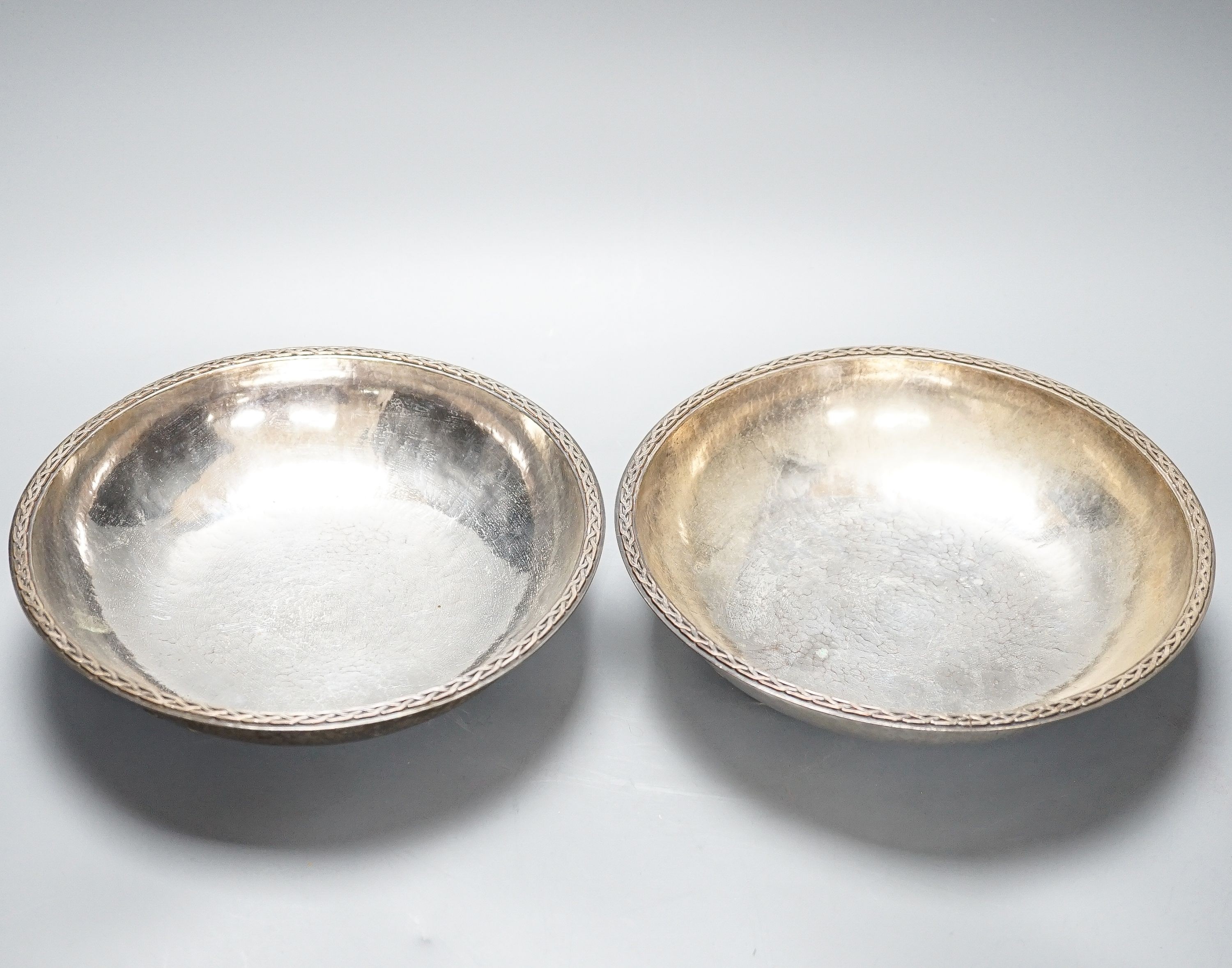 A pair of Keswick School of Industrial Arts silver plated bowls, on stylised spade feet, 23cm diameter